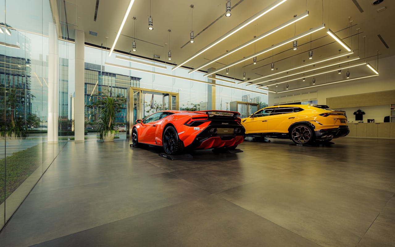 Home Showroom featuring luxury sports cars, Lamborghini models, with sleek design and modern architecture.