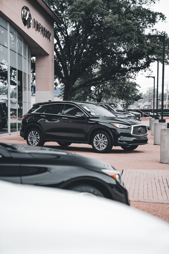 The Art of Drawing Readers In: Your attractive post title goes here A black SUV parked outside a dealership, showcasing modern design and style.